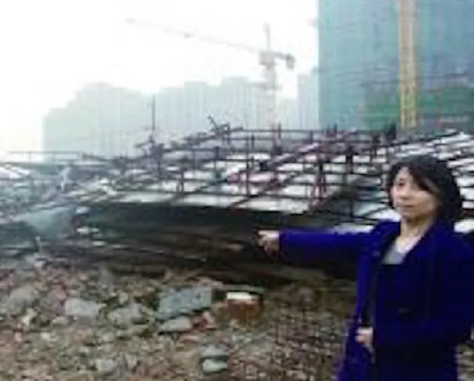 Ms. Shi standing next to her demolished house. (via Modern Express)