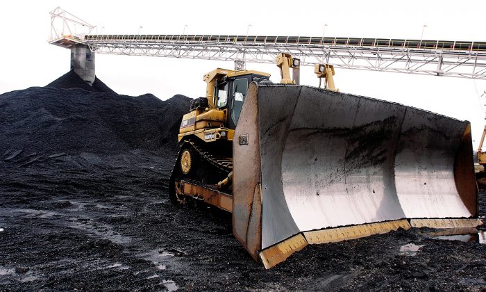 A large bulldozer sits ready for work at Peabody Energy's Gateway Coal Mine near Coulterville, Ill., on March 9, 2006. Illinois' coal production, which peaked in 1918 with a work force of more than 100,000, took a beating in the 1990s after the Clean Air Act required coal-fired power plants to either burn low-sulfur coal or install costly scrubbers to curb the emission of sulfur dioxide, a cause of acid rain. (AP Photo/Seth Perlman)