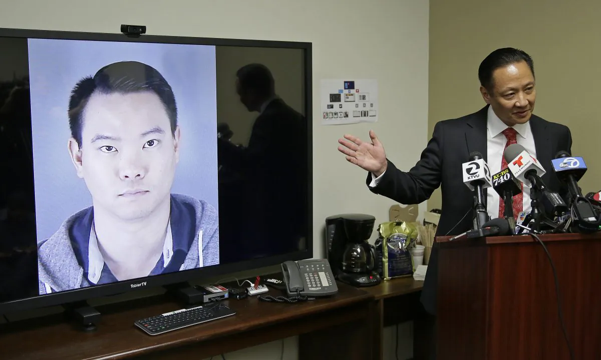 San Francisco Public Defender Jeff Adachi gestures while standing beside a picture of police officer Jason Lai during a news conference Tuesday, April 26, 2016, in San Francisco. (AP Photo/Eric Risberg)