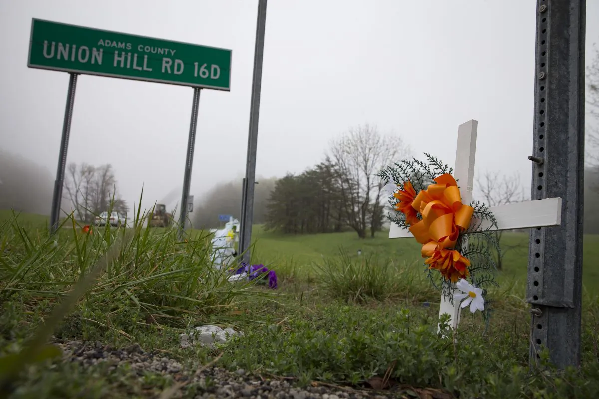 A small memorial stands beside the entrance on Union Hill Road at the outer perimeter of a crime scene, Wednesday, April 27, 2016, in Piketon, Ohio. (AP Photo/John Minchillo)