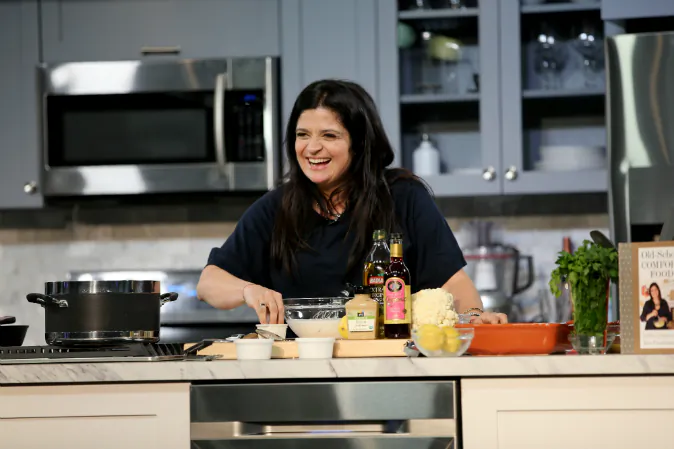 Chef Alex Guarnaschelli prepares food on stage during the Grand Tasting presented by ShopRite featuring Samsung culinary demonstrations presented by MasterCard - Food Network & Cooking Channel New York City Wine & Food Festival presented by FOOD & WINE at Pier 94 on October 17, 2015 in New York City. (Neilson Barnard/Getty Images for NYCWFF)