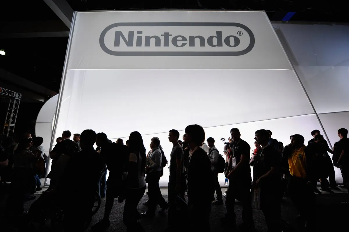 LOS ANGELES, CA - JUNE 07:  Crowds line up to view the new Nintendo game console Wii U at the Nintendo booth during the Electronic Entertainment Expo on June 7, 2011 in Los Angeles, California. The Wii U will have HD graphics, a controller with a 6.2 inch touchscreen and  be compatible with all other Wii accessories.    (Photo by Kevork Djansezian/Getty Images)