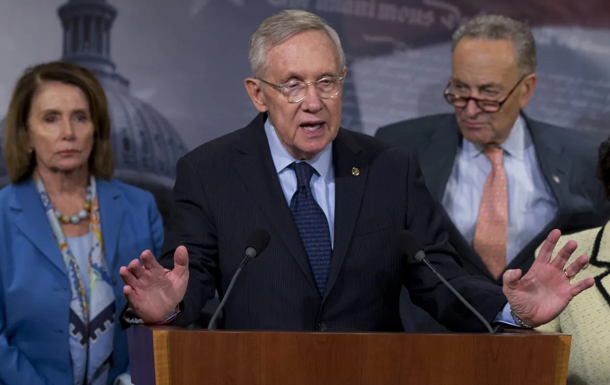Then-Senate Minority Leader Sen. Harry Reid (D-Nev.), joined by House Leader Nancy Pelosi (D-Calif.), left and Sen. Charles Schumer, (D-N.Y.), in a file photo. (Carolyn Kaster/AP Photo)