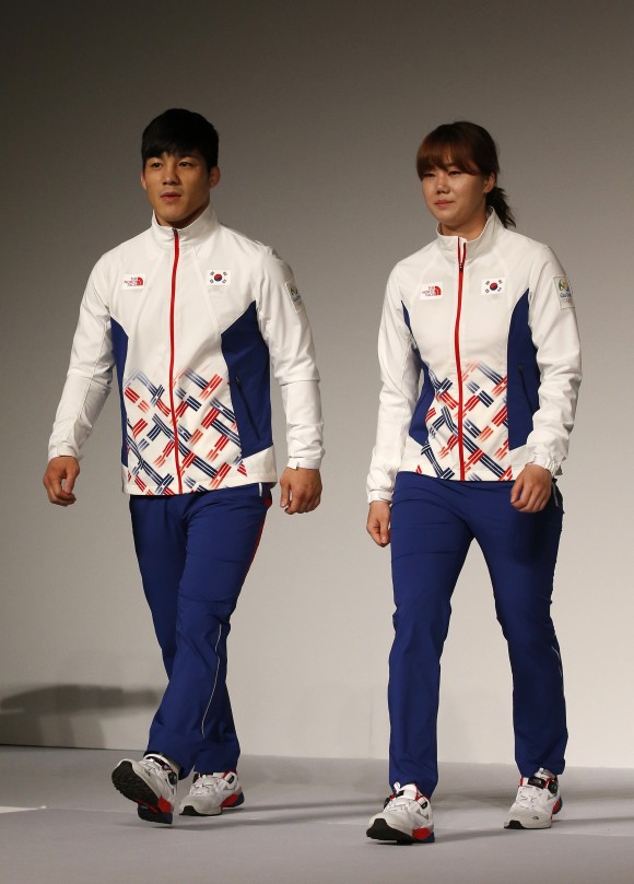 South Korean Olympic wrestling athlete Kim Hyeon-woo, left, and handball athlete Kim On-a, right, present the South Korean Olympic team uniforms for the medal ceremony of the 2016 Rio de Janeiro Olympic Games at Korean National Training Center in Seoul, South Korea, Wednesday, April 27, 2016. (AP Photo/Lee Jin-man)