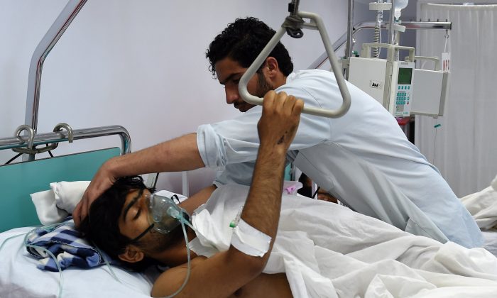 A wounded staff member of Doctors Without Borders (MSF), survivor of the US airstrikes on the MSF Hospital in Kunduz, receives treatment at the Italian aid organization, Emergency's hospital in Kabul on Oct. 6, 2015. (Wakil Kohsar/AFP/Getty Images)