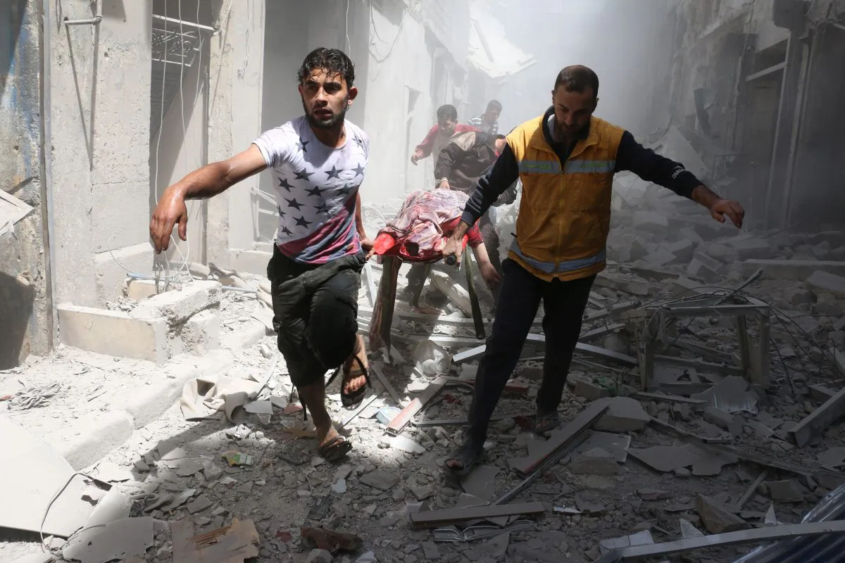 Syrian men carry a body on a stretcher amid the rubble of destroyed buildings following a reported air strike on the rebel-held neighbourhood of Al-Qatarji in the northern Syrian city of Aleppo, on April 29, 2016.
(Ameer Alhalbi/AFP/Getty Images)