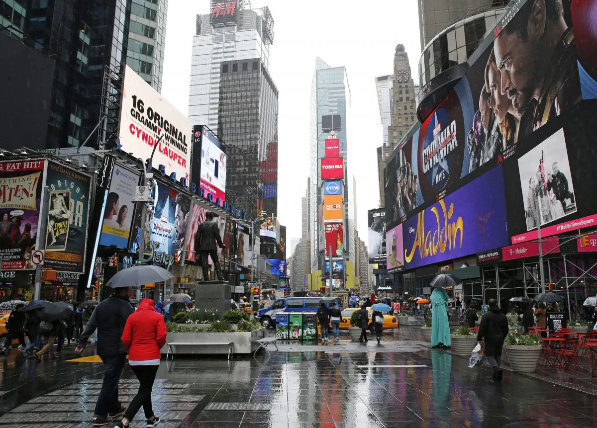 Pedestrians walk through Times Square on May 1, 2016, in New York, where Clear Channel Outdoor Americas operates some billboards. New York Sen. Charles Schumer is calling for a federal investigation into the advertising company's latest effort to target billboard ads to specific consumers with its so-called RADAR program which he calls "spying billboards," and warns that the service may violate privacy rights by tracking people’s cell phone data. (AP Photo/Kathy Willens)