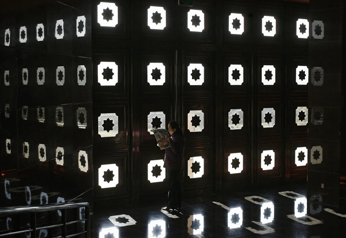 A woman reads a newspaper at the Museum of the War of Chinese People's Resistance Against Japanese Aggression, in Beijing, on Dec. 27, 2006. (Frederic J. Brown/AFP/Getty Images)
