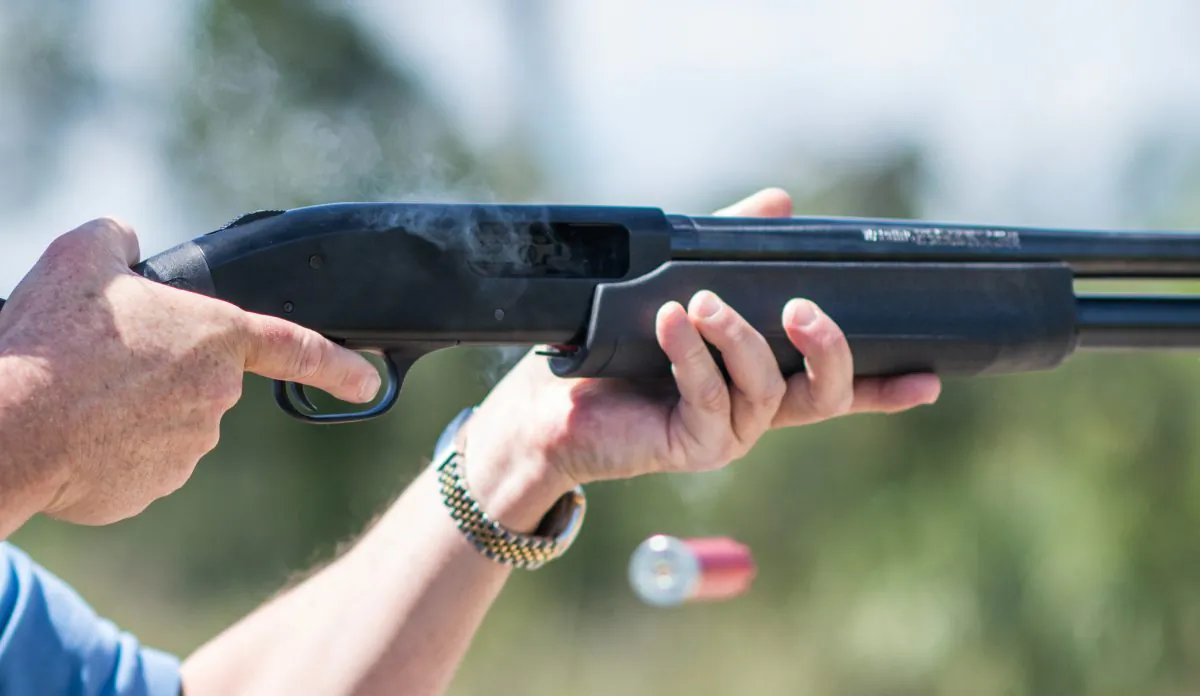 Jonathan Mossberg, whose iGun Technology Corp. is working to develop a "smart gun," poses with the firearm in Daytona Beach, Fla., on April 7, 2016. The firearm uses a ring to send a signal to prevent anyone but an authorized user from firing the weapon. (AP Photo/Lisa Marie Pane)