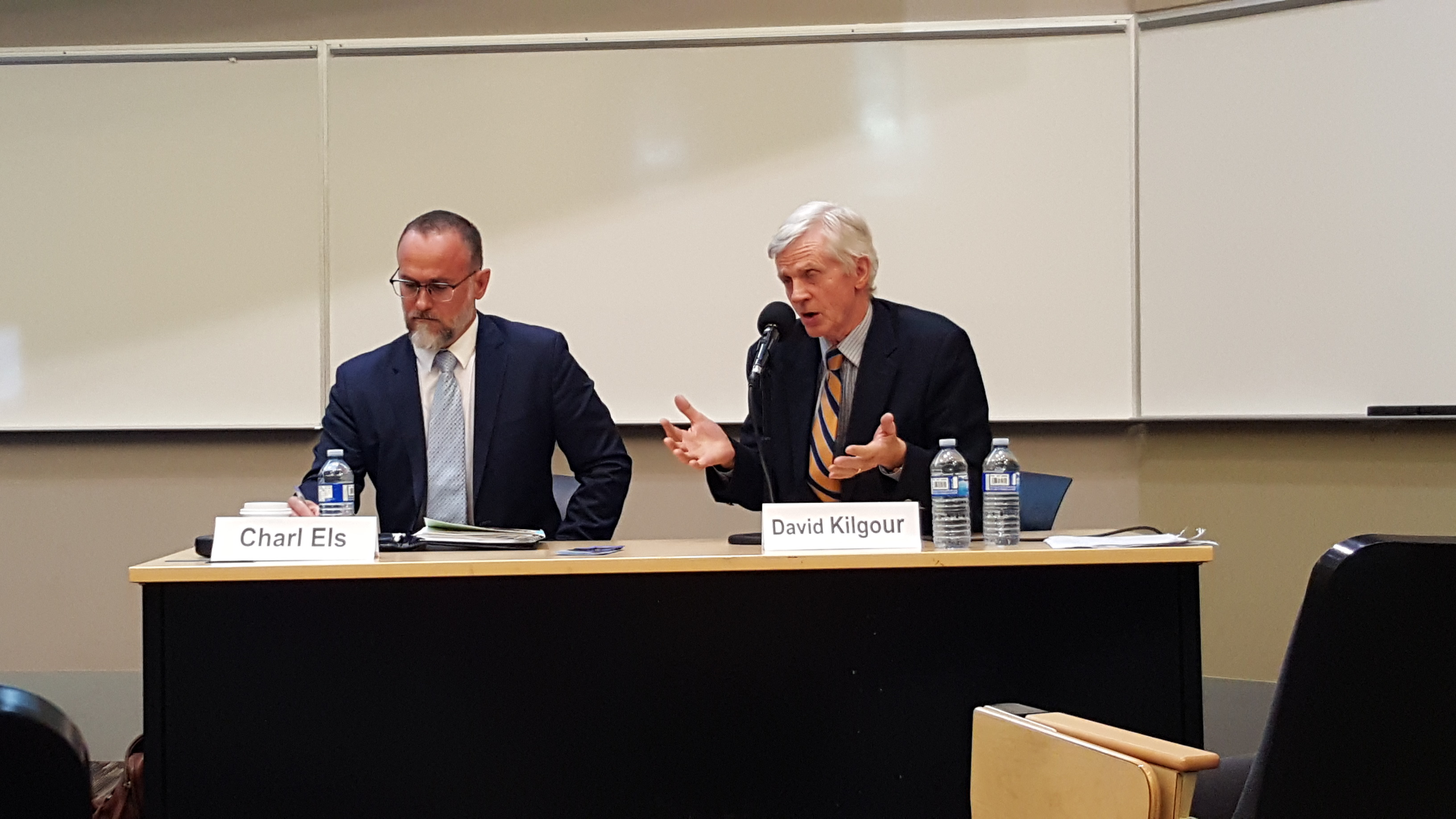 Dr. Charl Els (L), associate professor at the University of Alberta's department of psychiatry and the John Dossetor Health Ethics Centre, and David Kilgour, former Edmonton MP and secretary of state for Asia-Pacific, take part in a panel discussion following the screening of