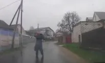 Video: Man Stops Driver, Does the Splits on the Wet Pavement