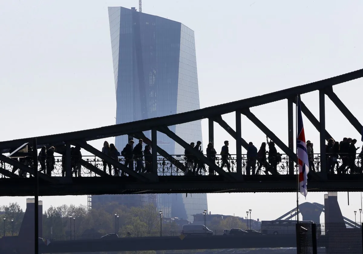 People walk over a bridge near the European Central Bank (background) in Frankfurt, Germany, on May 2, 2016. (Michael Probst/FILE PHOTO/AP)