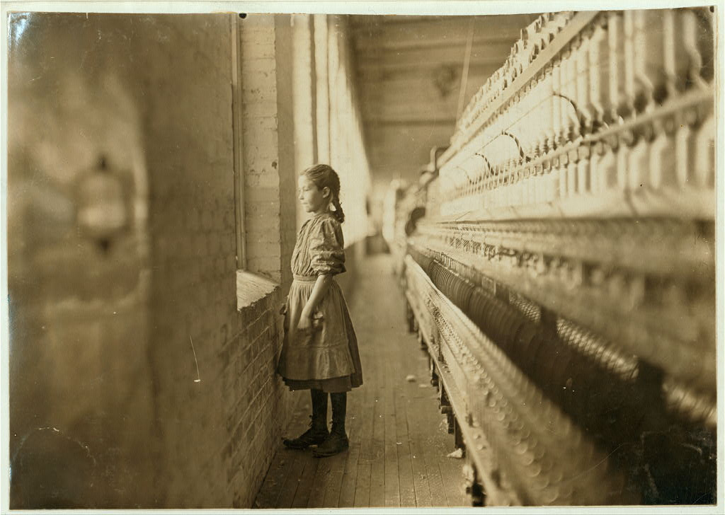 Rhodes Mfg. Co., Lincolnton, N.C. Spinner. A moments glimpse of the outer world Said she was 10 years old. Been working over a year. In Lincolnton, N. Carol., in November 1908. (L. W. Hine/LOC)