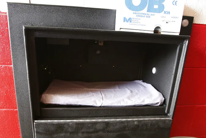 The Safe Haven Baby Box at the Woodburn, Ind., Volunteer Fire Department, is temperature-controlled and sounds an alarm when the door is opened. The baby box allows mothers to drop off unwanted newborns anonymously with emergency help moments away. The padded, climate-controlled container was dedicated Tuesday, April 26, 2016, at the Woodburn Volunteer Fire Department (Chad Ryan/The Journal Gazette via AP)