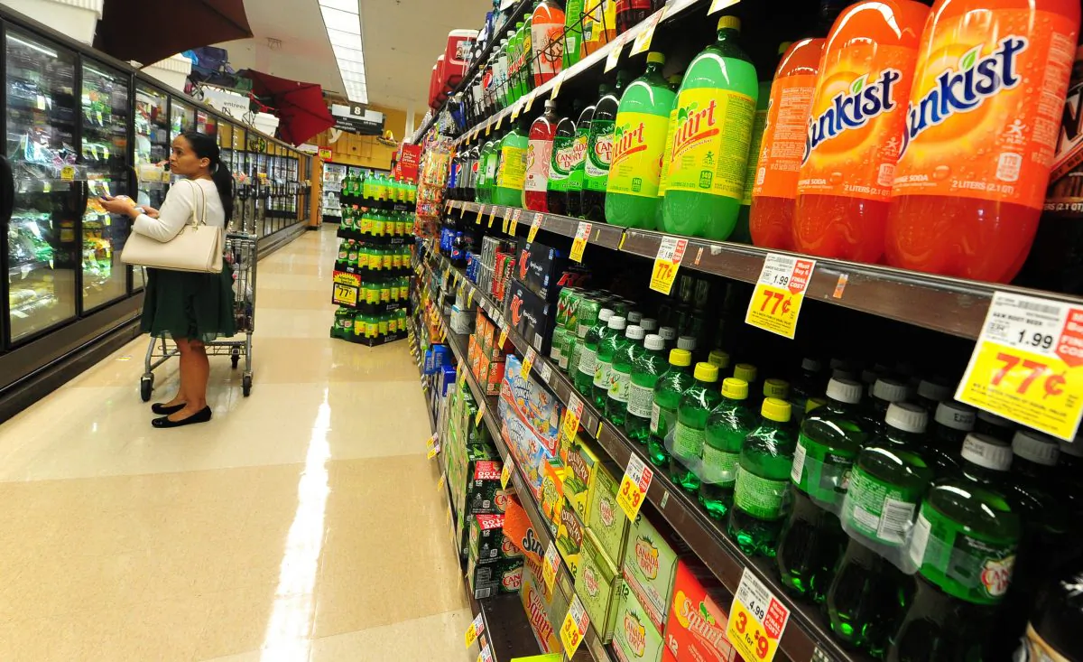 A woman shops for frozen foods on an aisle across from sodas and other sugary drinks for sale at a superrmarket in Monterey Park, California on June 18, 2014. (FREDERIC J. BROWN/AFP/Getty Images)