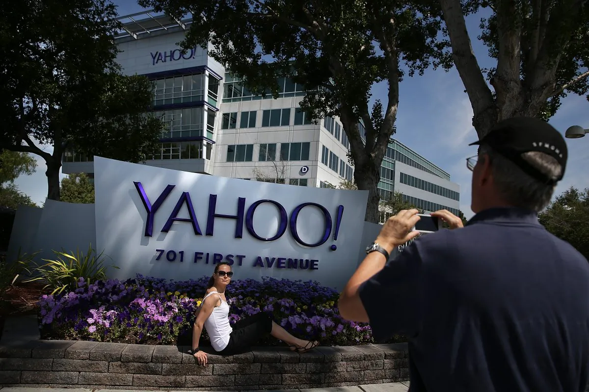 People take pictures in front of a sign that posted in outside of the Yahoo! headquarters in Sunnyvale, Calif., on May 23, 2014. (Justin Sullivan/Getty Images)