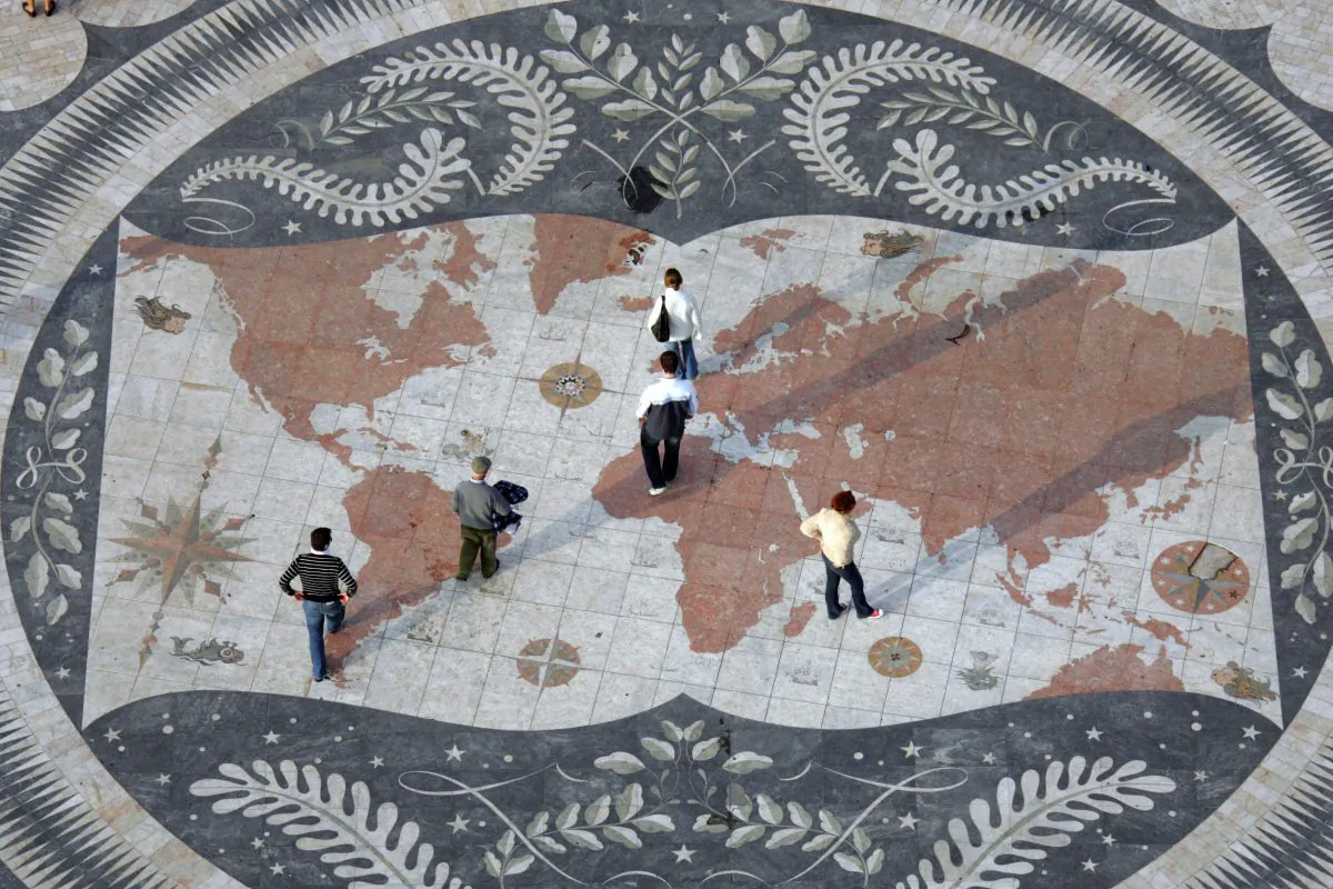 People walk on huge world map in Lisbon on Jan. 5, 2007. (Damien Meyer/AFP/Getty Images)