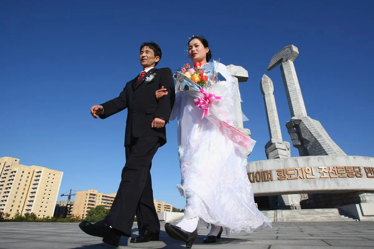 Hu Kwang Rim and his wife Hwang Ju Ok celebrate their wedding at the Monument of Party's foundation of DPR Korea in Pyongyang, North Korea, on Oct. 19, 2007. (Alexander Hassenstein/Getty Images)