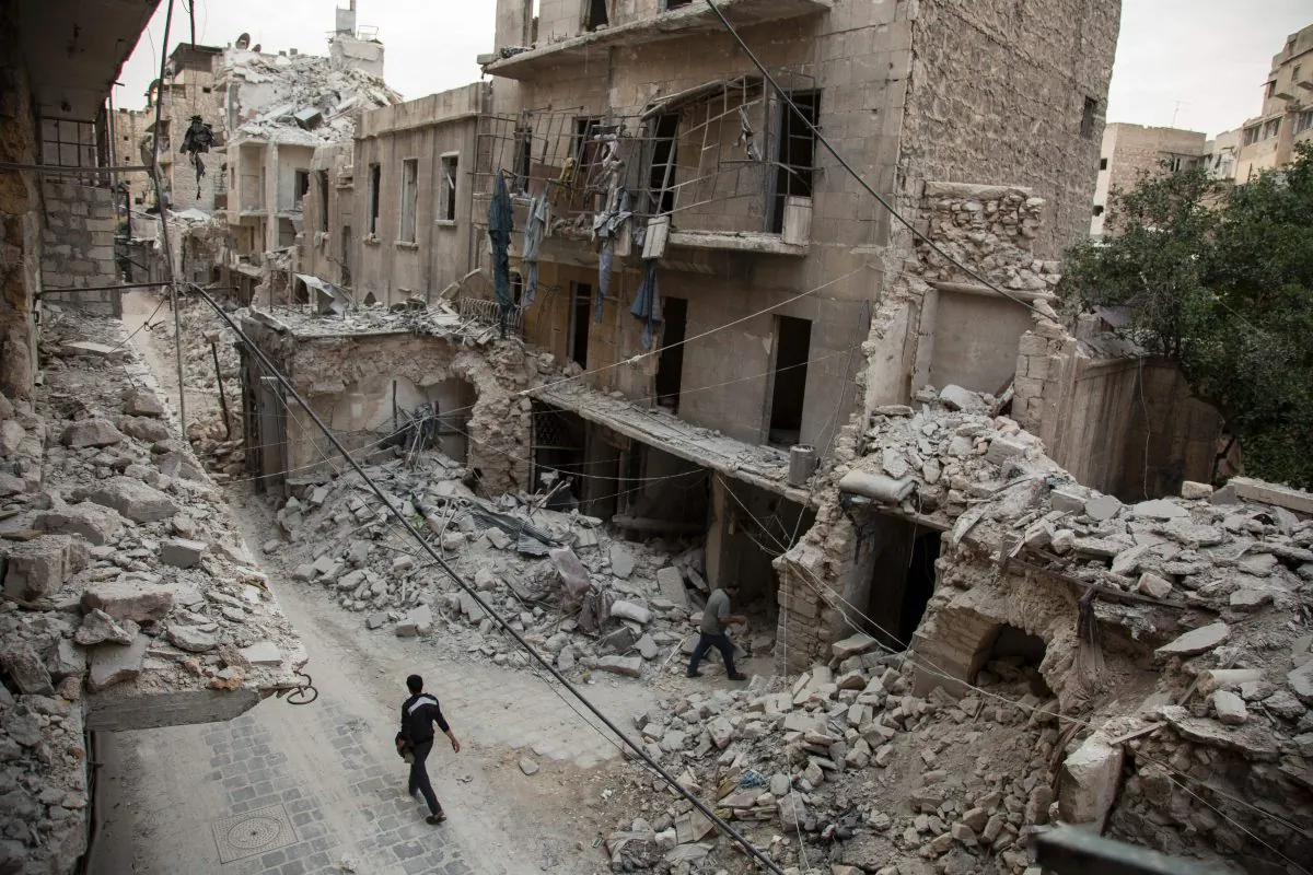 A Syrian man walks past destroyed buildings on May 2, 2016, in Aleppo's Bab al-Hadid neighborhood which was targeted recently by regime airstrikes. Aleppo residents ventured out onto the streets, taking advantage of a lull in violence in the northern Syrian city as the United States pushed to salvage a ceasefire. (Karam al-Masri/AFP/Getty Images)