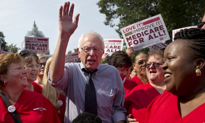 FILE - In this July 30, 2015 file photo, Democratic presidential candidate, Sen. Bernie Sanders, I-Vt., waves after speaking at a rally with registered nurses and other community leaders celebrate the 50th anniversary of Medicare and Medicaid, on Capitol Hill Washington. With the Obama administration counting down its final year, many Democrats are finding less to like about the president’s health care law, unsure about its place among their party’s achievements. Sanders’ call for “Medicare for all” seems to have rekindled aspirations for bigger changes beyond “Obamacare.” That poses a challenge for Hillary Clinton, who’s argued that the health care law is working and the nation needs to build on it, not start over. (AP Photo/Jacquelyn Martin, File)