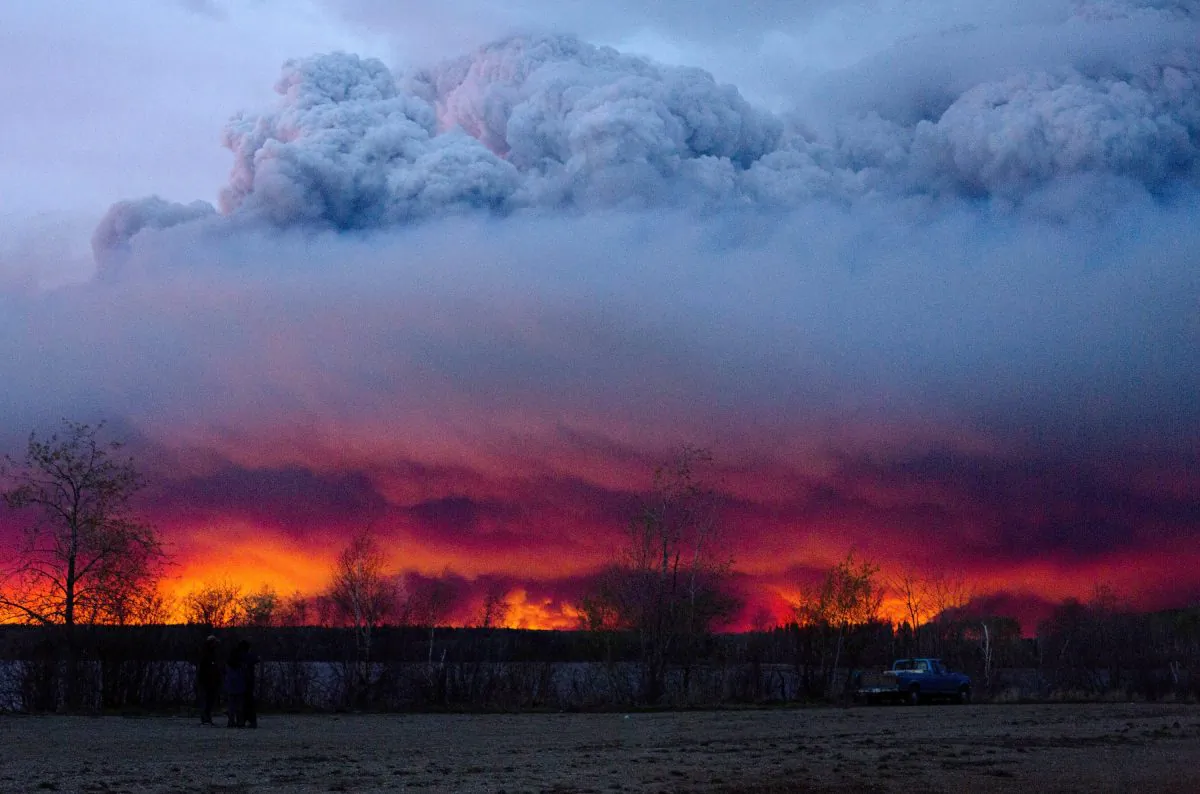 A wildfire moves towards the town of Anzac from Fort McMurray, Alberta, on May 4, 2016. Alberta declared a state of emergency Wednesday as crews frantically held back wind-whipped wildfires. Unseasonably hot temperatures combined with dry conditions have transformed the boreal forest in much of Alberta into a tinder box. (Jason Franson/The Canadian Press via AP) MANDATORY CREDIT