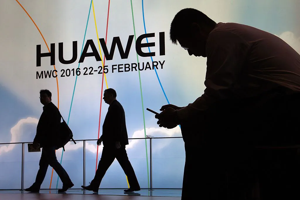 A man uses a mobile phone next to the stand of Chinese telecoms firm Huawei at the Mobile World Congress in Barcelona, Spain on Feb. 22, 2016. (Lluis Gene/AFP/Getty Images)