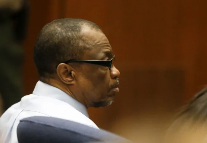 Lonnie Franklin Jr., left, appears in Los Angeles Superior Court during closing arguments of his trail Monday, May 2, 2016, in Los Angeles. The Grim Sleeper serial killer trial is coming to a close in Los Angeles after months of testimony. Franklin is charged with killing nine women and a 15-year-old girl between 1985 and 2007. They were shot or strangled and their bodies dumped in alleys and trash bins in South Los Angeles and nearby areas. (Mark Boster/Los Angeles Times via AP, Pool)