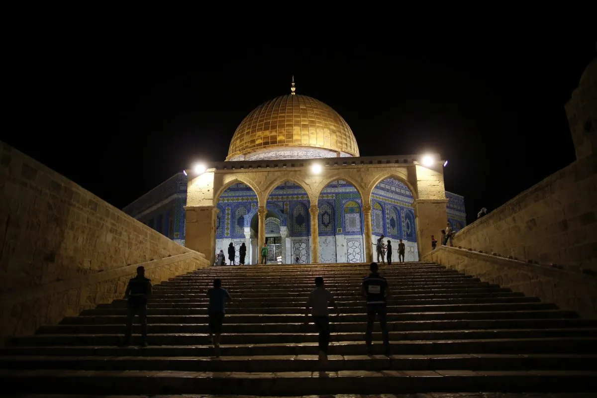 Palestinian walk past the Dome of the Rock in the al-Aqsa Mosque compound in Jerusalem during "tarawih" prayer marking the first evening of Islam's holy month of Ramadan, on June 6, 2016. (Ahmad Gharabli/AFP/Getty Images)