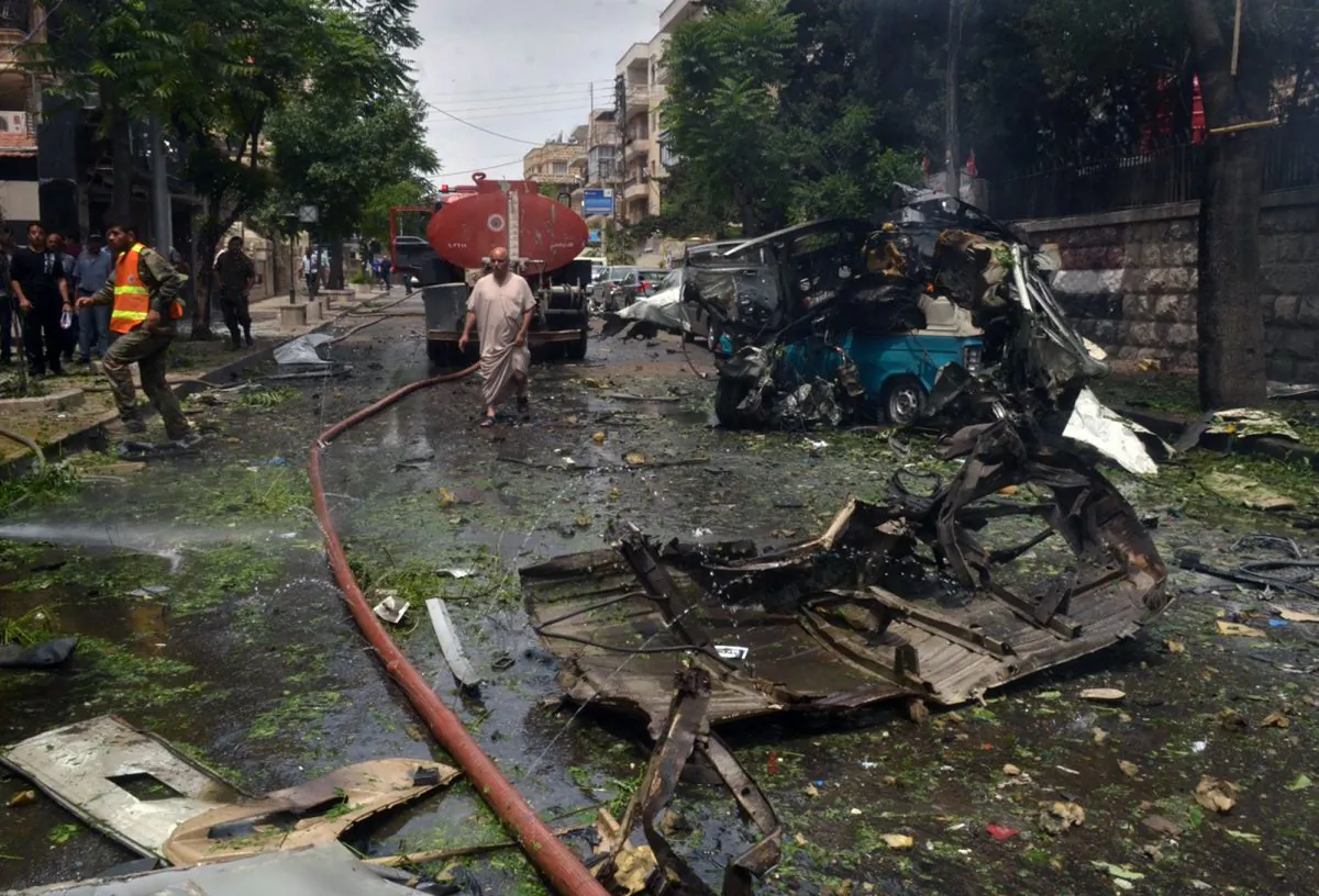In this photo released by the Syrian official news agency SANA, Syrian citizens and firefighters gather at the scene where one of rockets hit the Dubeet hospital in the central neighborhood of Muhafaza in Aleppo, Syria, Tuesday, May 3, 2016. Shells and mortar rounds are raining down on every neighborhood Aleppo," said Aleppo-based health official Mohammad Hazouri, speaking from Al-Razi hospital.  (SANA via AP)