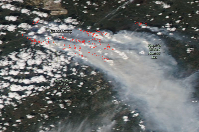 A May 5, 2016, satellite image of Fort McMurray with fires or heat anomalies marked in red. (Screenshot of NASA Worldview)