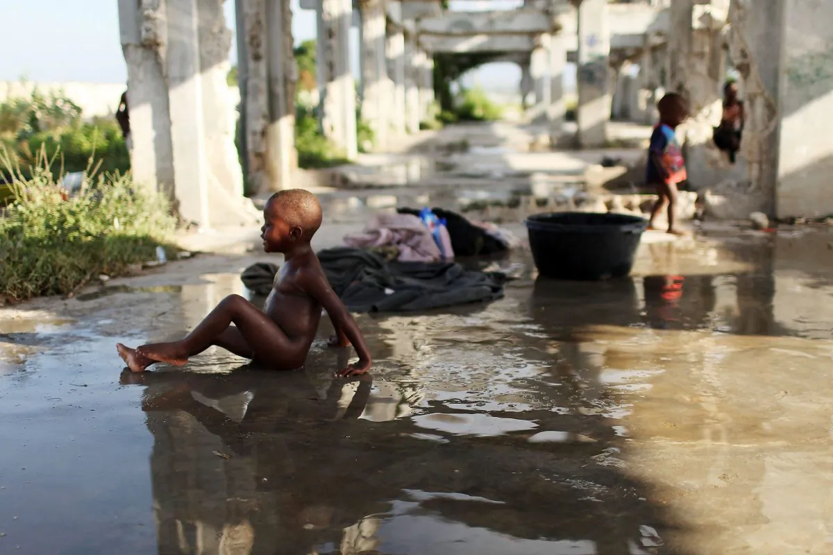 A boy bathes in a camp for individuals who have lost their homes in the Jan. 12, 2010 earthquake, in Cite Soleil, a historically impoverished area of Port-au-Prince, Haiti, on Oct. 31, 2010. (Spencer Platt/Getty Images)