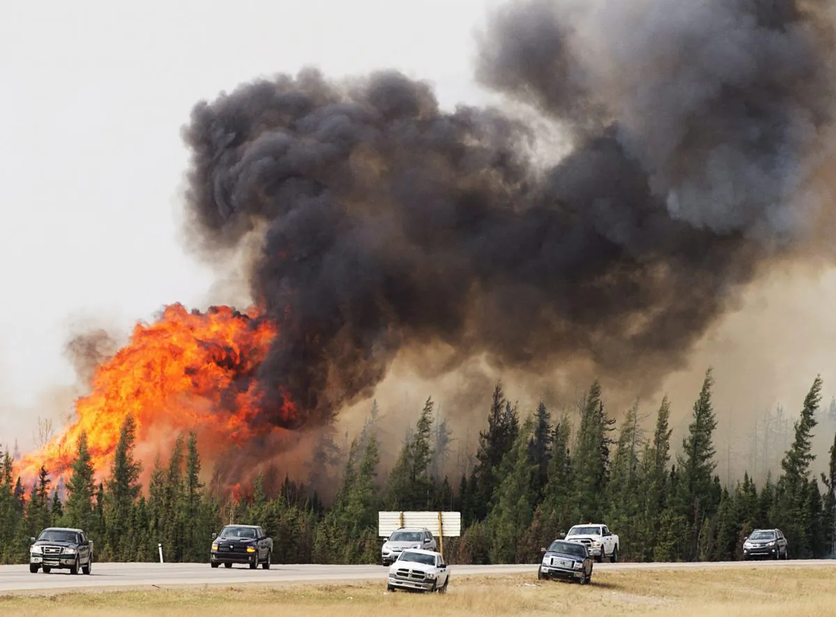 A wildfire burns south of Fort McMurray, Alberta, near Highway 63 on Saturday, May 7, 2016. (Ryan Remiorz/The Canadian Press via AP)