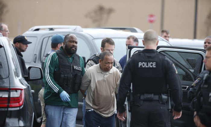 Police take Eulalio Tordil, 62, a suspect in three fatal shootings in the Washington, D.C., area into custody in Bethesda, Md., Friday, May 6, 2016. Tordil is an employee of the Federal Protective Service, which provides security at federal properties. He was put on administrative duties in March after a protective order was issued against him. (AP Photo/Alex Brandon)