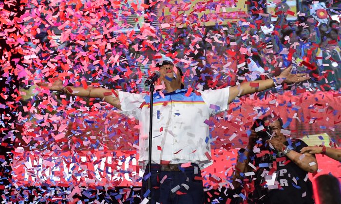 Ferdinand Marcos Jr., vice-presidential candidate and son of the late dictator Ferdinand Marcos, reacts as confetti rains during his "miting-de-avance" in Manila, Philippines, on May 5, 2016. (Ted Aljibe/AFP/Getty Images)