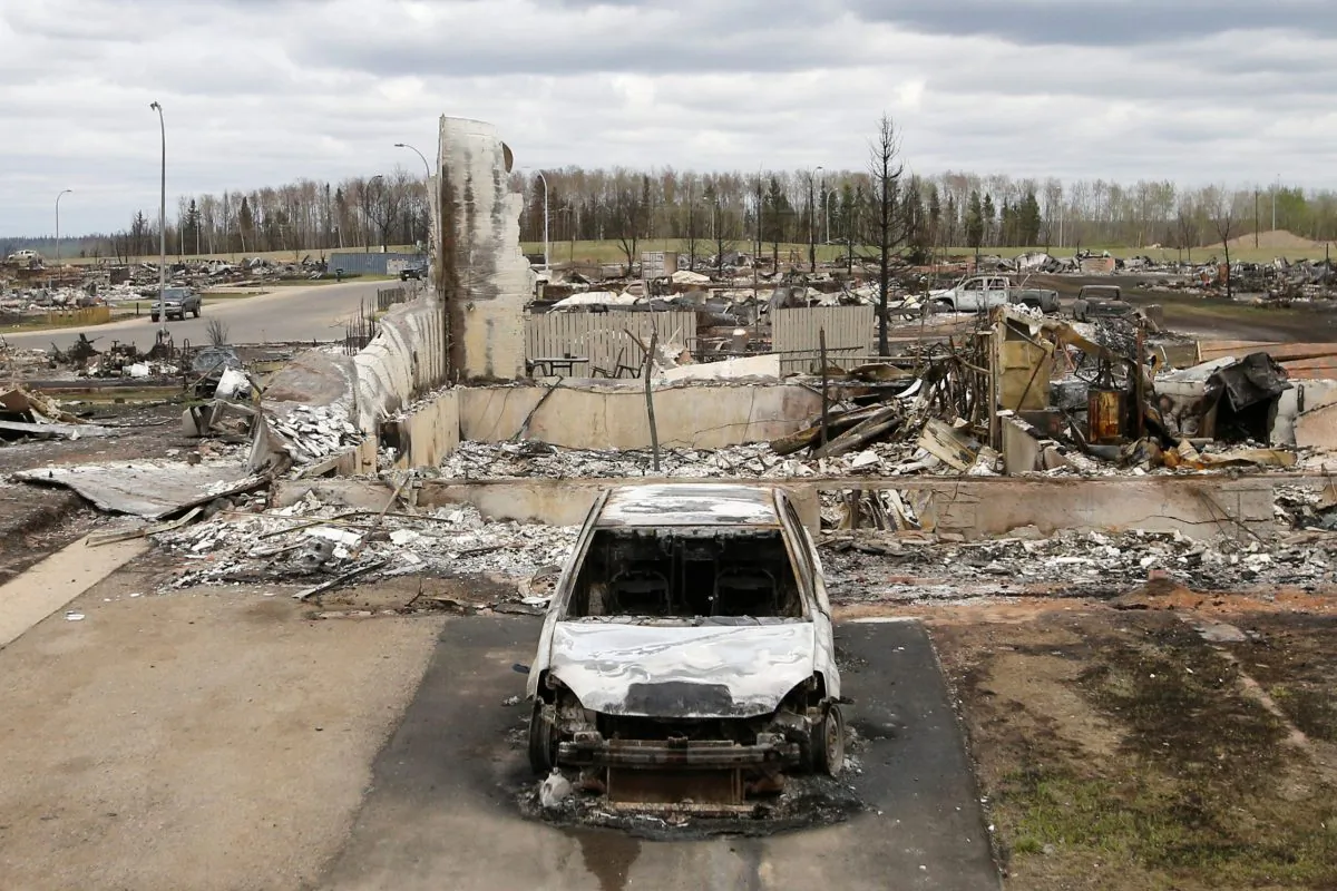 A charred vehicle and home are pictured in the Beacon Hill neighbourhood of Fort McMurray, Alberta, Canada, May 9, 2016 after wildfires forced the evacuation of the town.
(Chris Wattie/AFP/Getty Images)