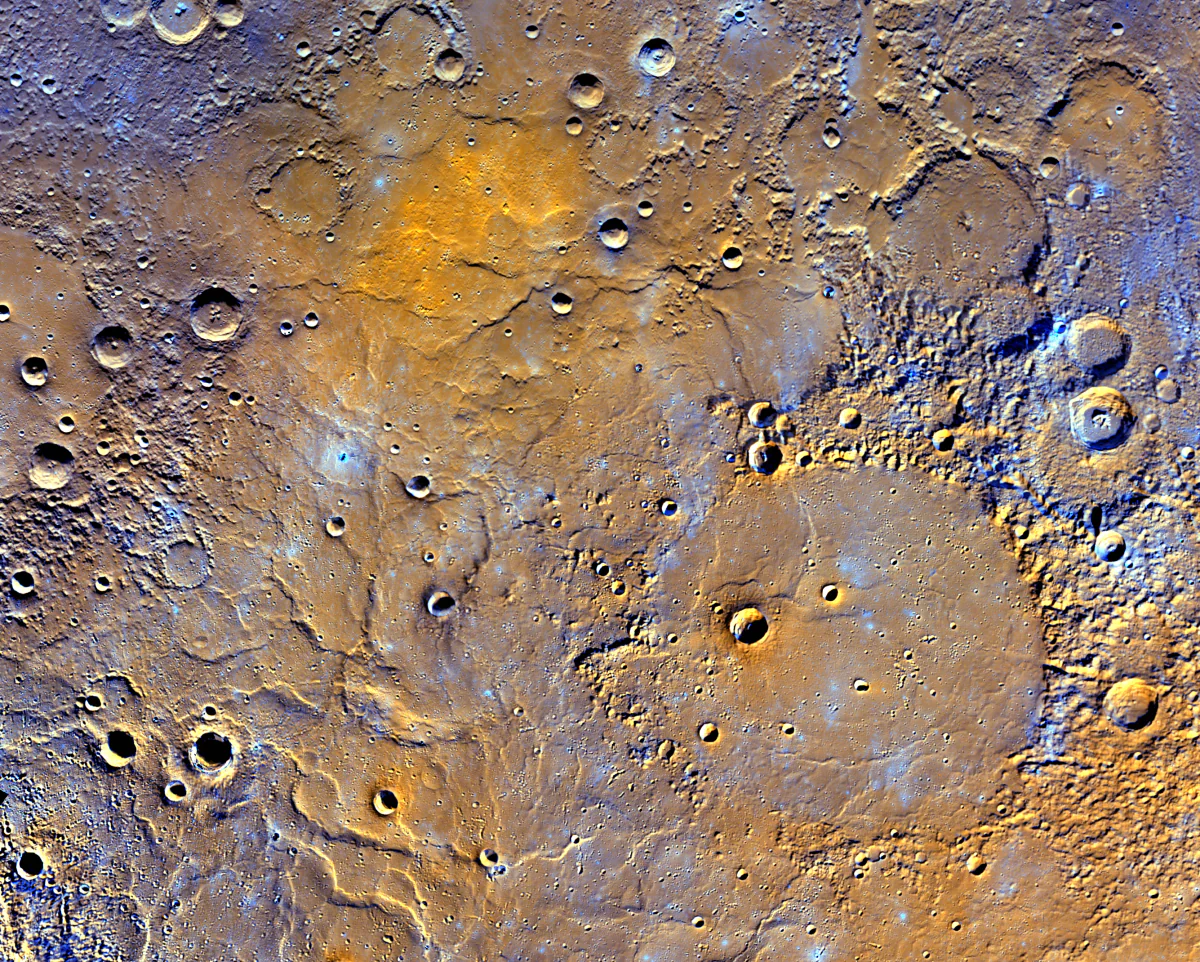 A view of Mercury’s northern volcanic plains is shown in enhanced color to emphasize different types of rocks on Mercury’s surface. (NASA/JHUAPL/Carnegie Institution of Washington)