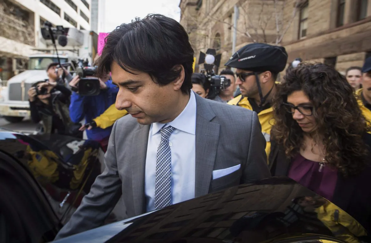 Former CBC host Jian Ghomeshi leaves a Toronto court with his sister, Jila Ghomeshi, after signing a peace bond, May 11, 2016. (The Canadian Press/Mark Blinch)