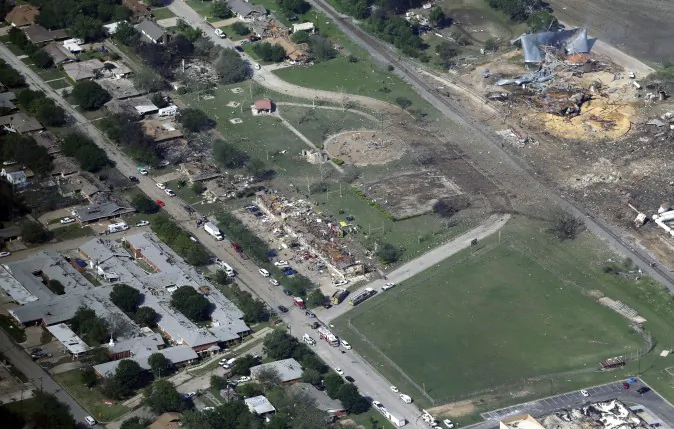 This April 18, 2013 aerial file photo shows the remains of a nursing home, left, apartment complex, center, and fertilizer plant, right, destroyed by an explosion at a fertilizer plant in West, Texas. Federal authorities announced Wednesday, May 11, 2016, that the fire that caused the deadly explosion in 2013 was a criminal act. The explosion killed 15 people, injured hundreds and left part of the small town in ruins. (AP Photo/Tony Gutierrez, File)