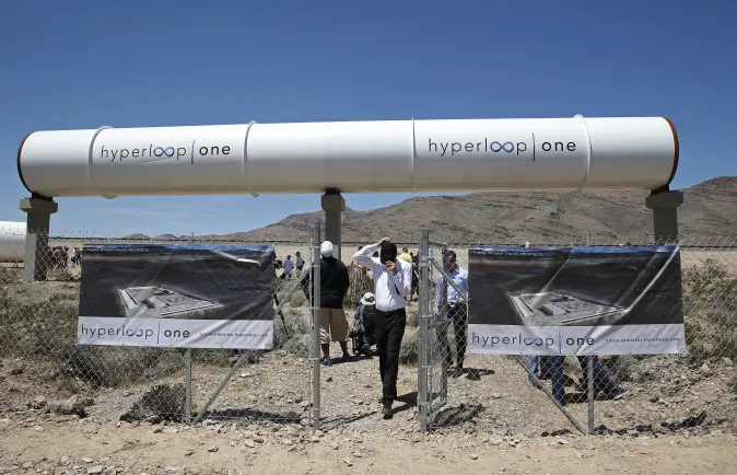 People tour the site after a test of a Hyperloop One propulsion system, Wednesday, May 11, 2016, in North Las Vegas, Nev. The startup company opened its test site outside of Las Vegas for the first public demonstration of technology for a super-speed, tube based transportation system. (AP Photo/John Locher)
