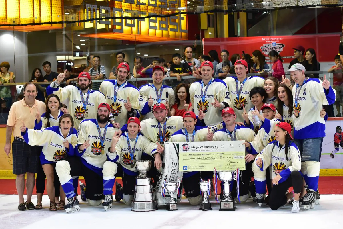 Nation celebrate their victory in the in the International division of the 2016 Mega Ice Hockey 5s, at Mega Ice on Saturday May 7, 2016, together with Ms Czarina Man, Director of MegaBox and a few of their special friends. (Bill Cox/Epoch Times)