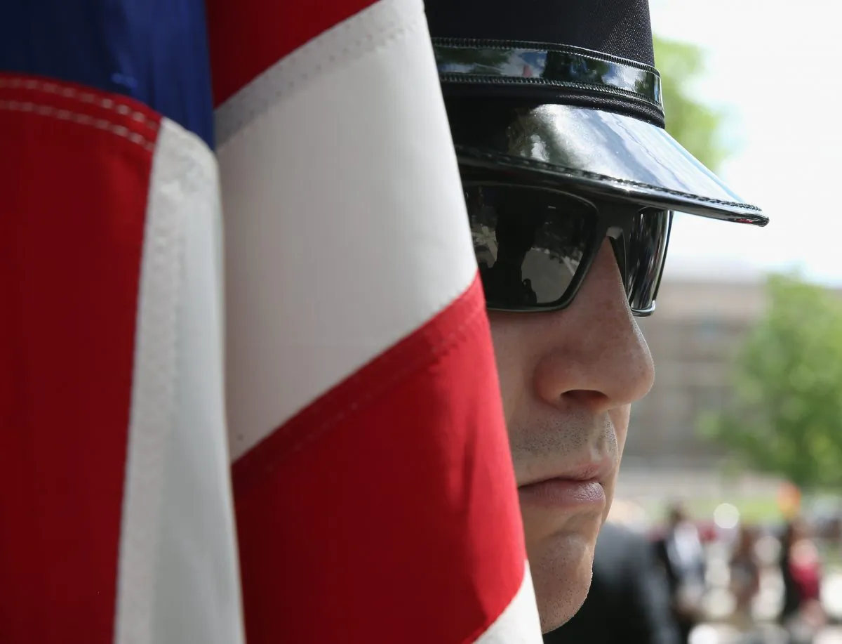 A member of the U.S. Immigration and Customs Enforcement Honor Guard holds an American flag during a ICE Valor Memorial wreath laying Ceremony at the National Law Enforcement Officers Memorial in Washington, D.C., on May 11, 2015. (Mark Wilson/Getty Images)