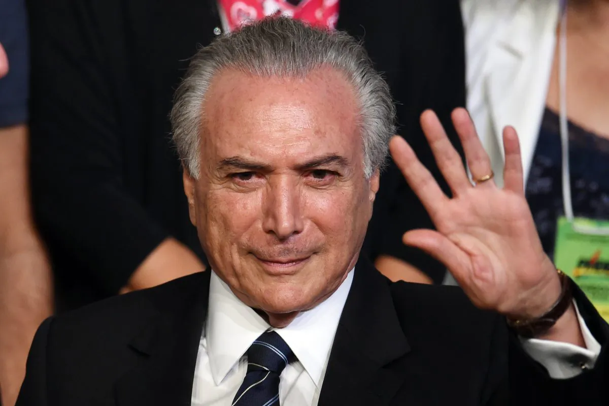 Brazilian Vice President Michel Temer waves during the Brazilian Democratic Movement Party (PMDB) national convention in Brasilia, on March 12, 2016. (Evaristo Sa/AFP/Getty Images)