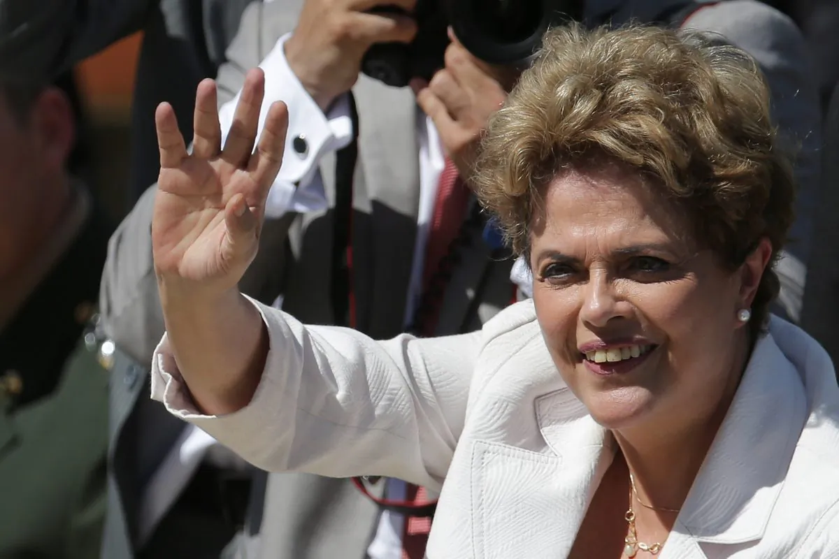 Brazilian President Dilma Rousseff greets supporters as she leaves Planalto president palace in Brasilia, Brazil, Thursday, May 12, 2016.  Hours after the Senate voted to suspend her, Rousseff blasted the impeachment process against her as "fraudulent" and promised to fight what she characterized as an injustice more painful than the torture she endured under a past military dictatorship. (AP Photo/Eraldo Peres)