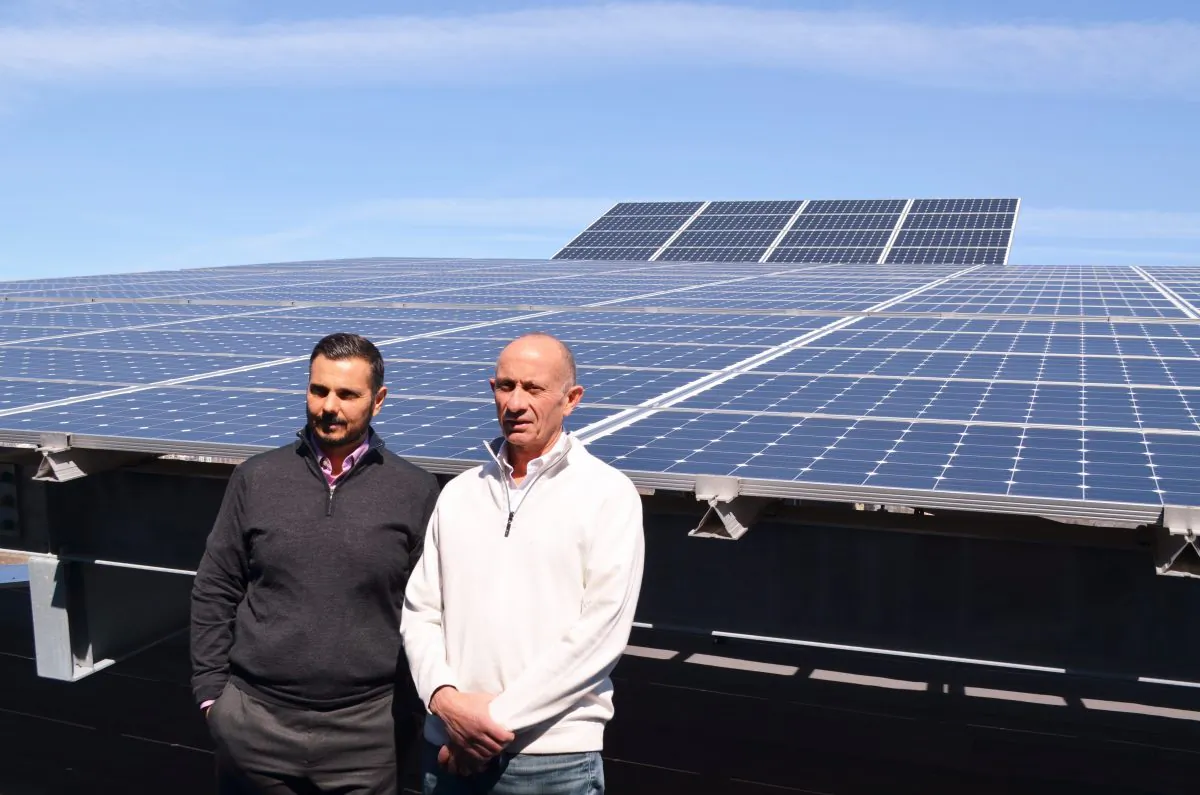 Del Ridge Homes principals George Le Donne and David De Sylva, in front of a roof top solar array similar to what will be installed on the roof of GEM II. (Courtesy of Del Ridge Homes)