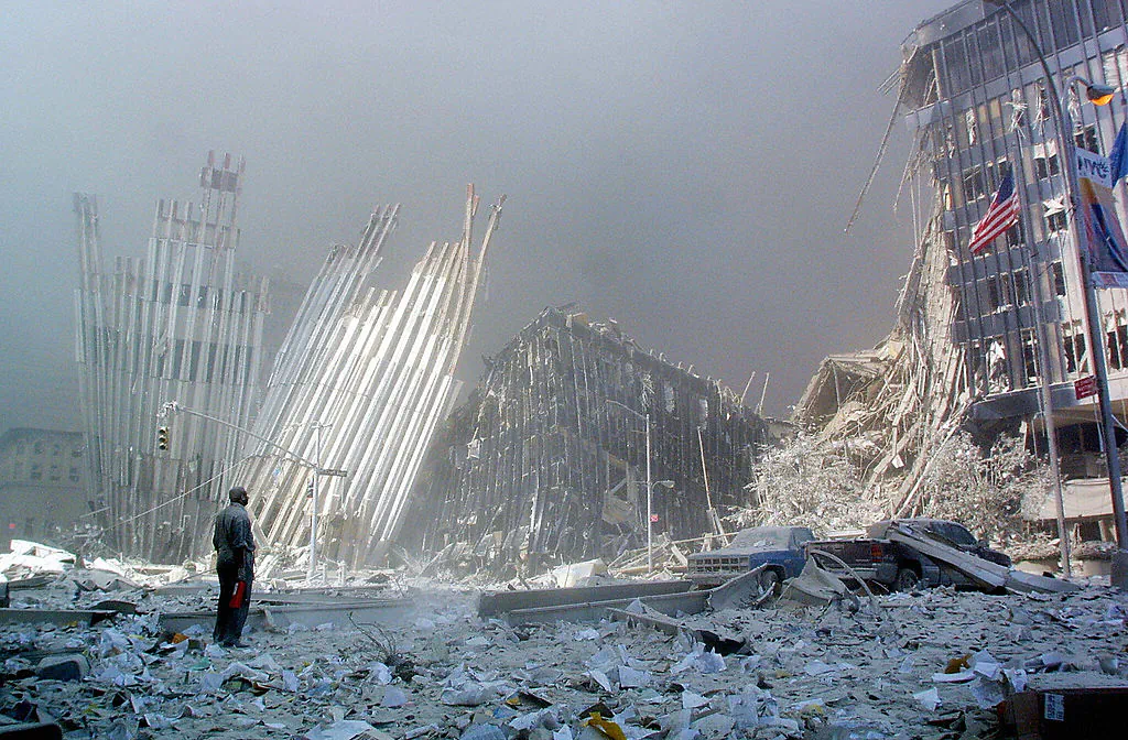 A man standing amid rubble, calling out asking if anyone needs help, following the collapse of the first World Trade Center tower in New York after two hijacked planes crashed into the buildings. (Doug Kanter/AFP/Getty Images)