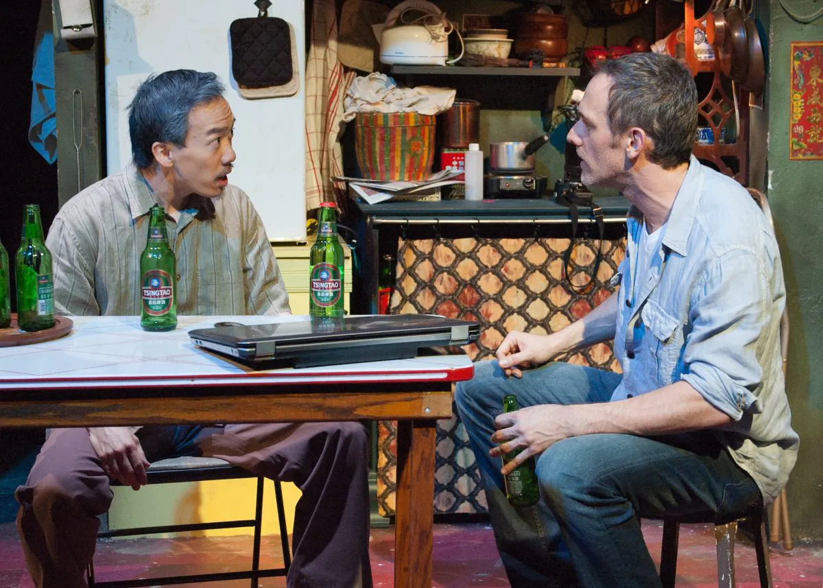 (L--R) Friends Zhang Lin (Norman Yap) and Joe Schofield (Coburn Goss) share beers and recall the day when the iconic “Tank Man” photo was taken.  (Lara Goetsch)