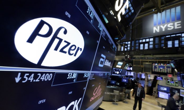 The Pfizer logo on a screen above its trading post on the floor of the New York Stock Exchange on April 6, 2016. (AP Photo/Richard Drew)