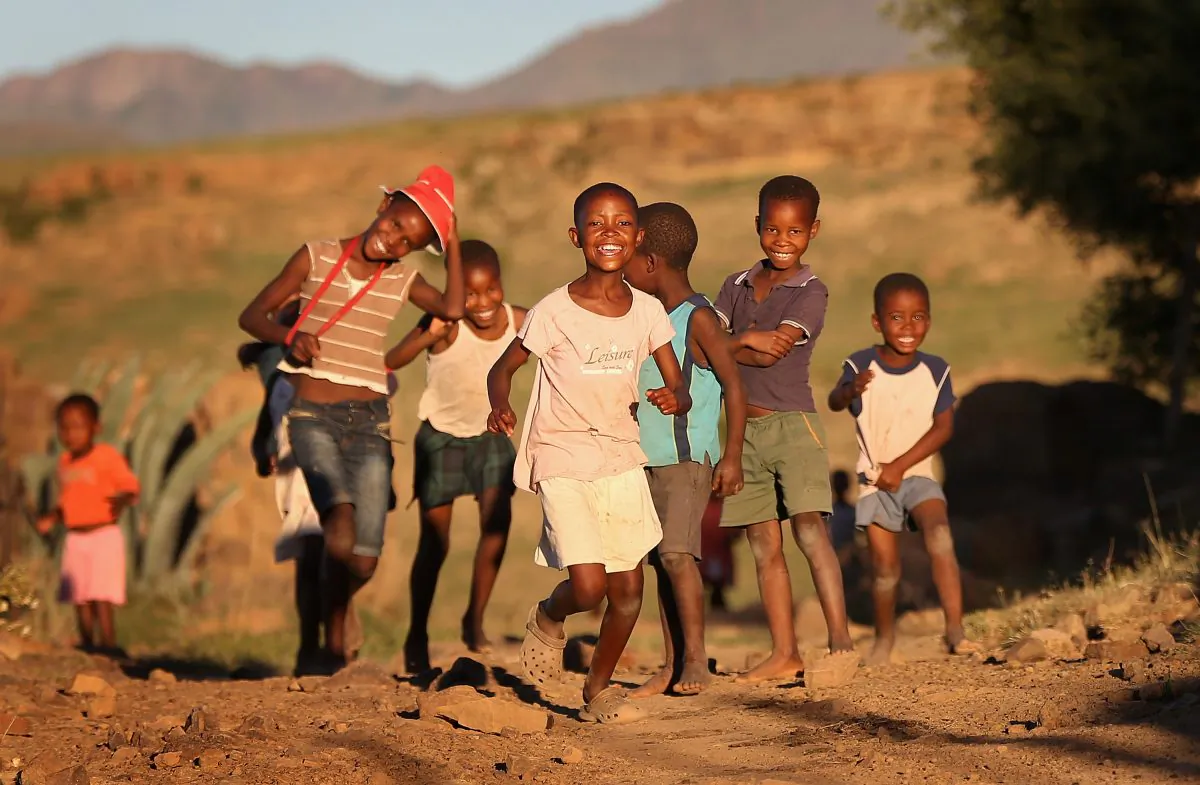 Children run towards charity workers in Morija, Lesotho, on Feb. 23, 2013. (Chris Jackson/Getty Images)