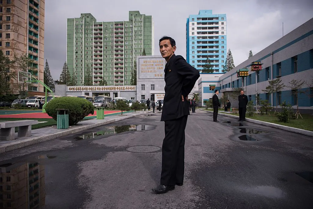 A guide stands in a courtyard outside the March 26 Electric Cable Factory in Pyongyang on May 6, 2016. (Ed Jones/AFP/Getty Images)