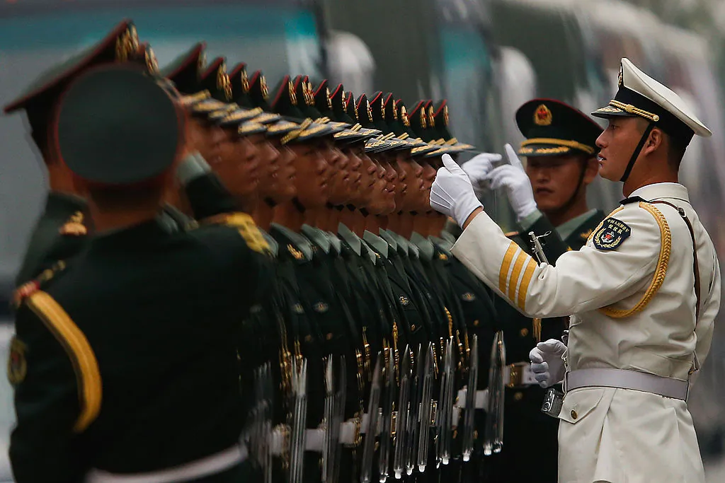Chinese soldiers stand for inspection during a welcoming ceremony for Venezuela President Nicolas Maduro Moros in Beijing on Sept. 22, 2013. The Chinese regime has started dismantling business ventures run by its military. (Lintao Zhang/Getty Images)